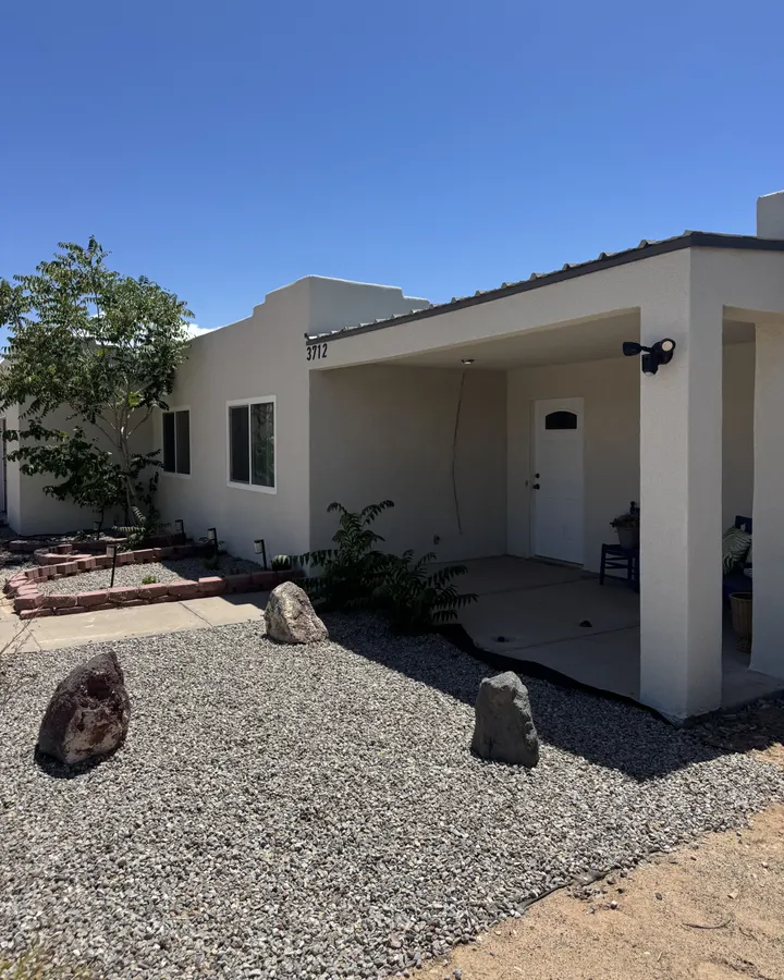Front of a stucco home with new windows