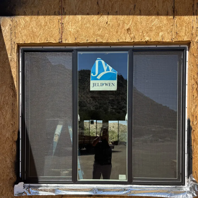 New slider window in a sheathed opening with the manufacturer label still on the glass