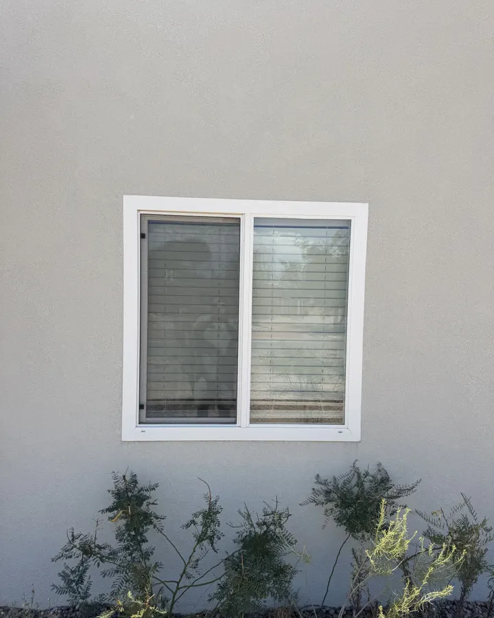 White window in a stucco wall